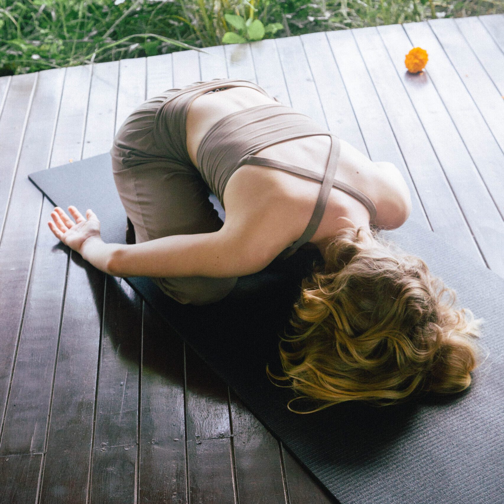 Woman in yoga pose on mat.