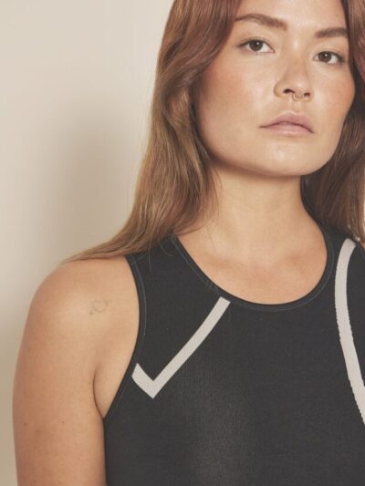 Black top with a round neck, wide straps, and white graphic designs