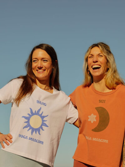 2 women wearing Yin and Yang t-shirts with white and orange patterns
