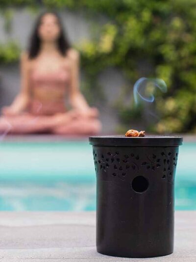 Black stone diffuser with a candle emitting smoke