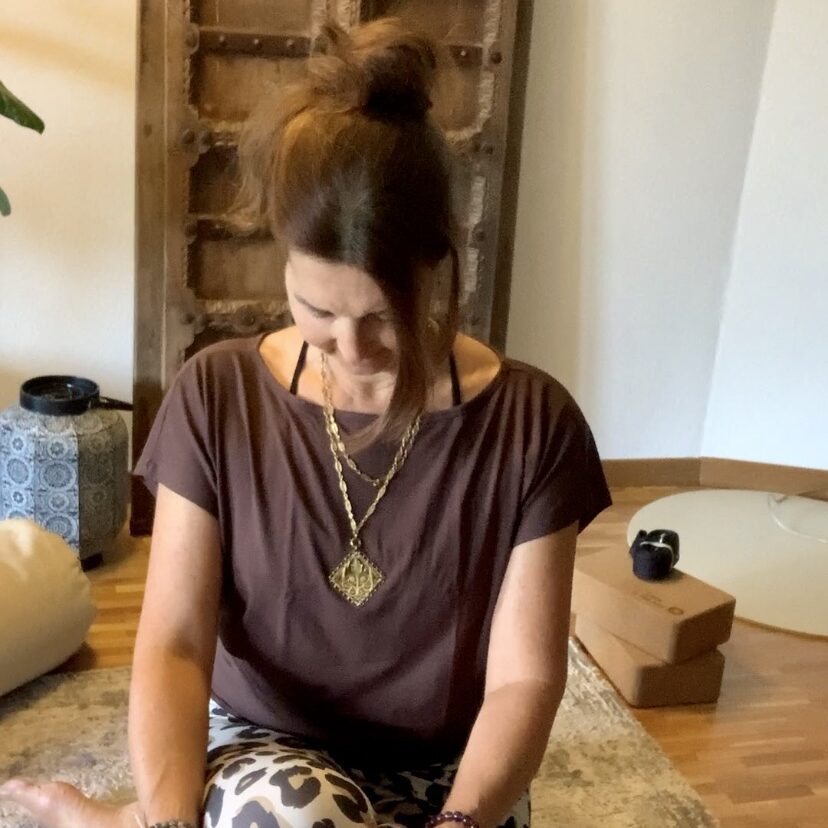 Woman meditating in a peaceful yoga studio