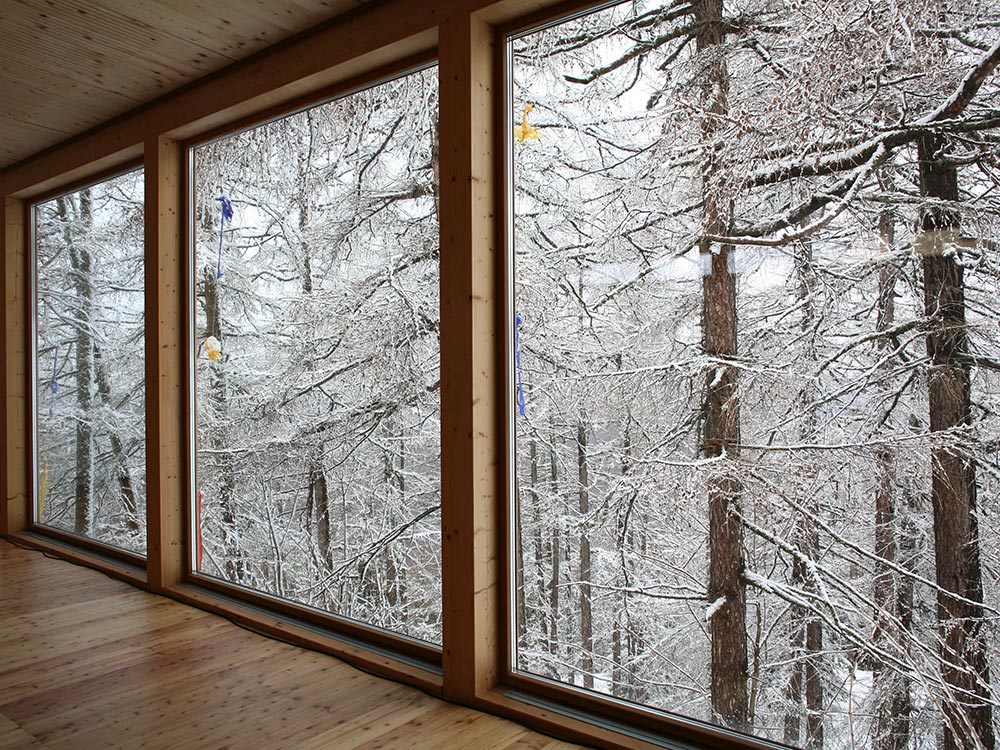 Yoga room at Hotel Beau-Site in Valais with a view of the snowy forest