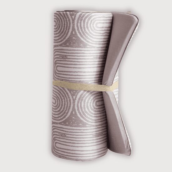 Rolled grey yoga mat with circular patterns