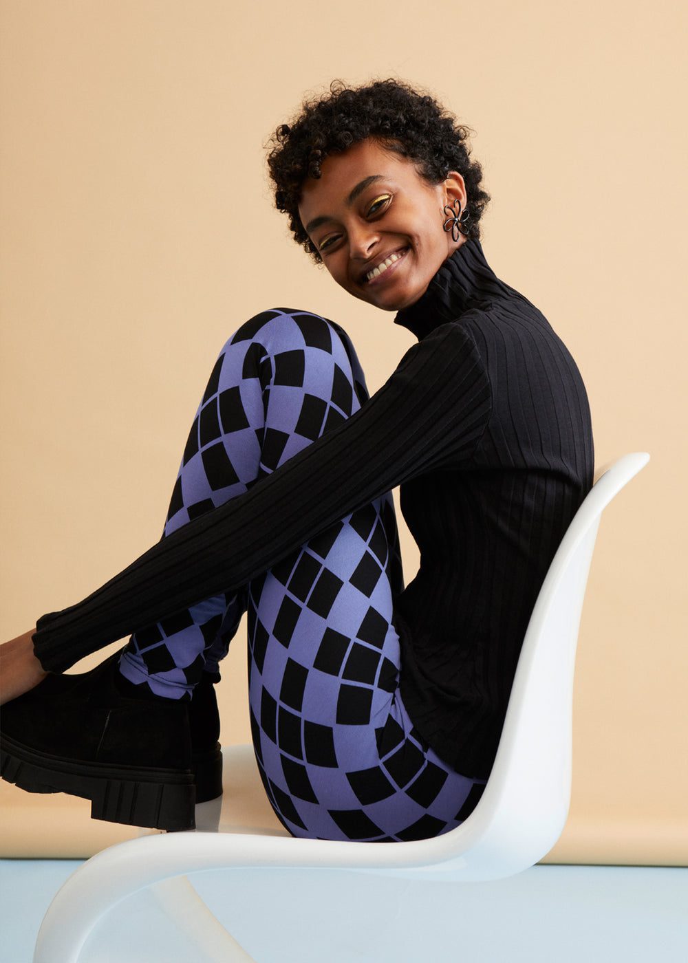 Smiling woman in purple diamond-patterned pants
