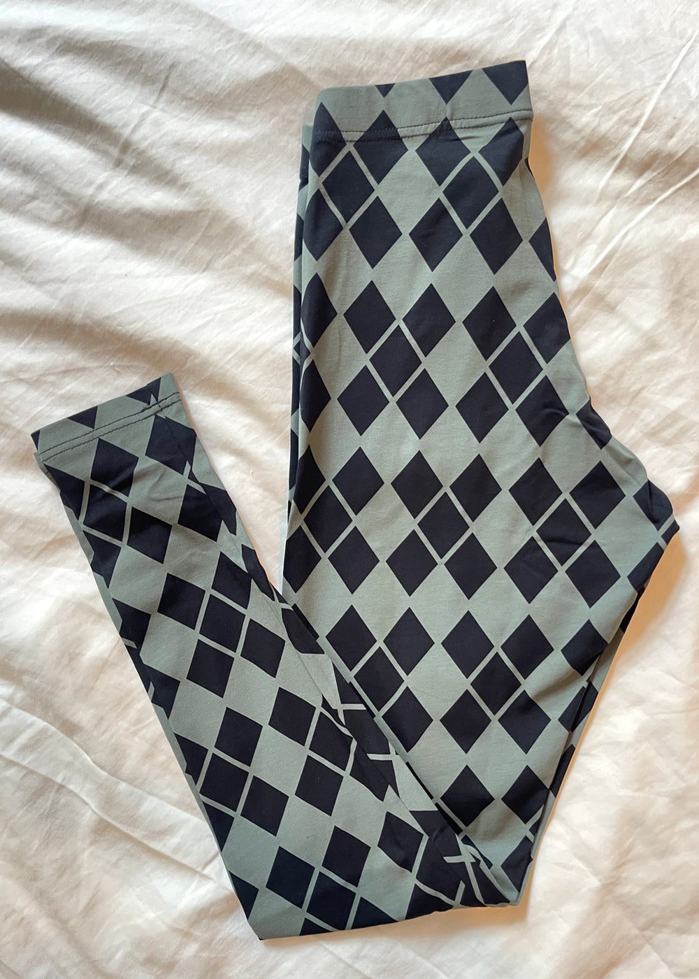 Leggings with black diamonds on a light grey background