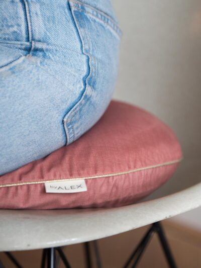 Person sitting on a pink fabric balance cushion by ByAlex