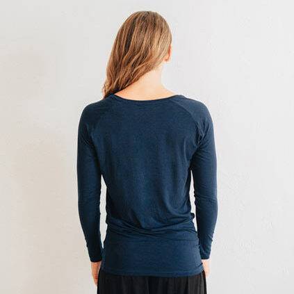 Woman wearing a navy long sleeve top.