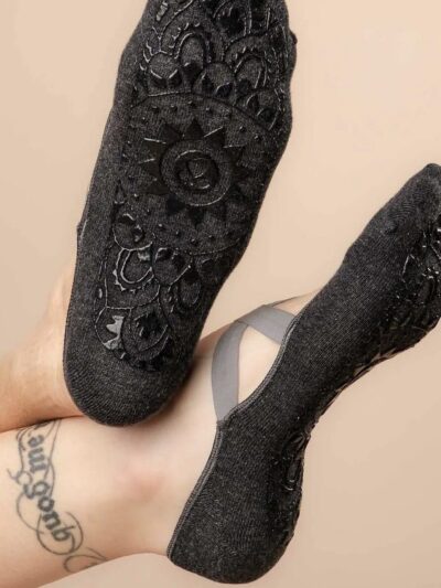 2 feet wearing non-slip sole socks for pilates and yoga