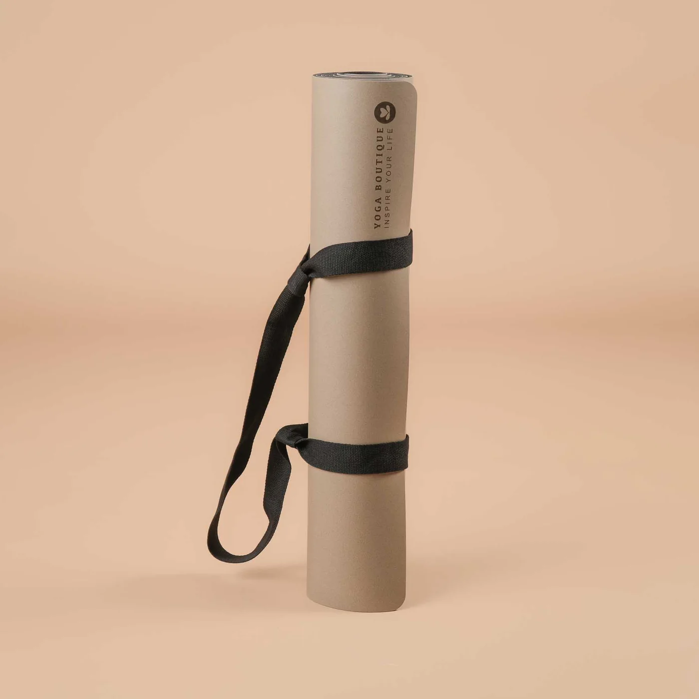 Rolled yoga mat with black strap