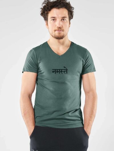 Man wearing a dark green short-sleeved T-shirt with a black Sanskrit inscription meaning namaste, and a V-neck.