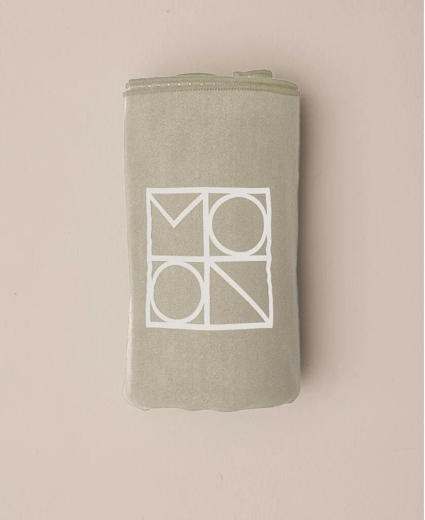 Beige folded towel with MOON logo