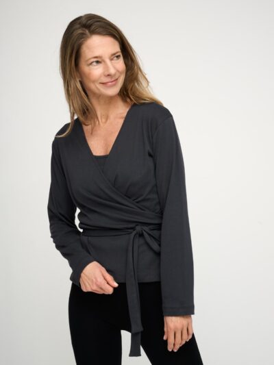 Woman wearing a black long-sleeved top.