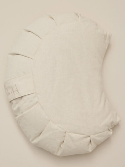 Half-moon-shaped meditation cushion made of unbleached cotton, as seen from above