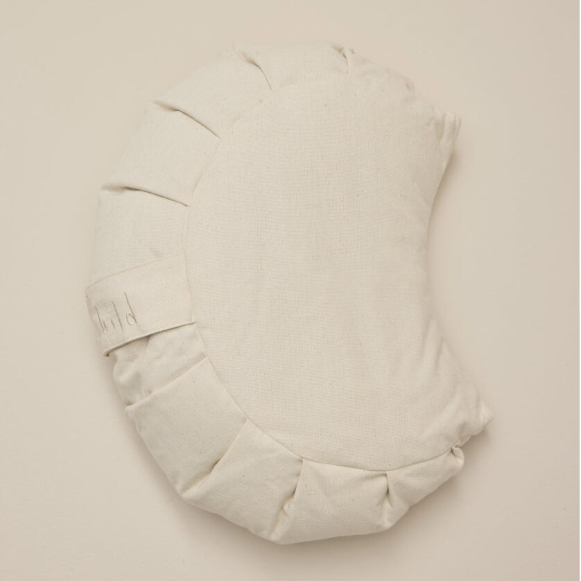 Half-moon-shaped meditation cushion made of unbleached cotton, as seen from above